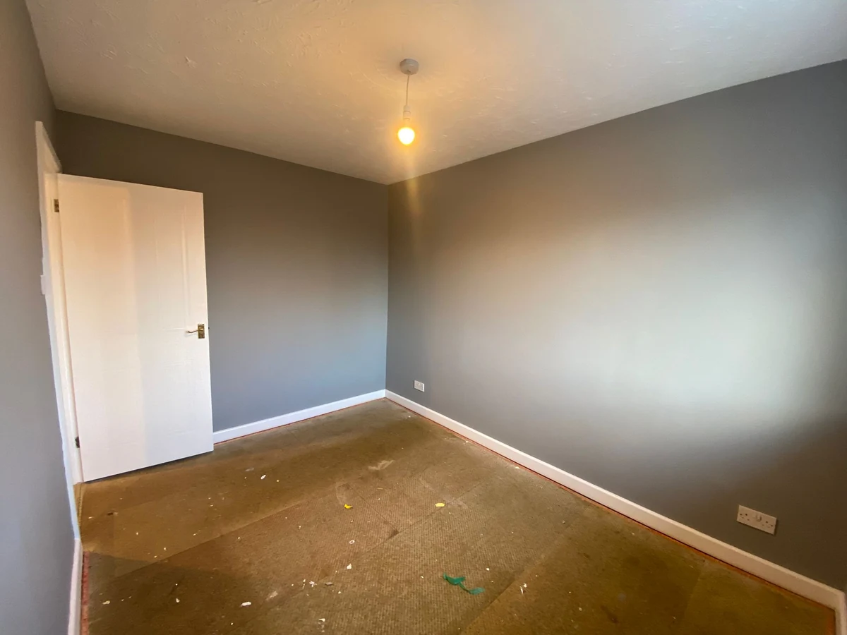 Bedroom painting with dark grey walls and white skirting boards in Cwmbwrla by Daffodil Decor
