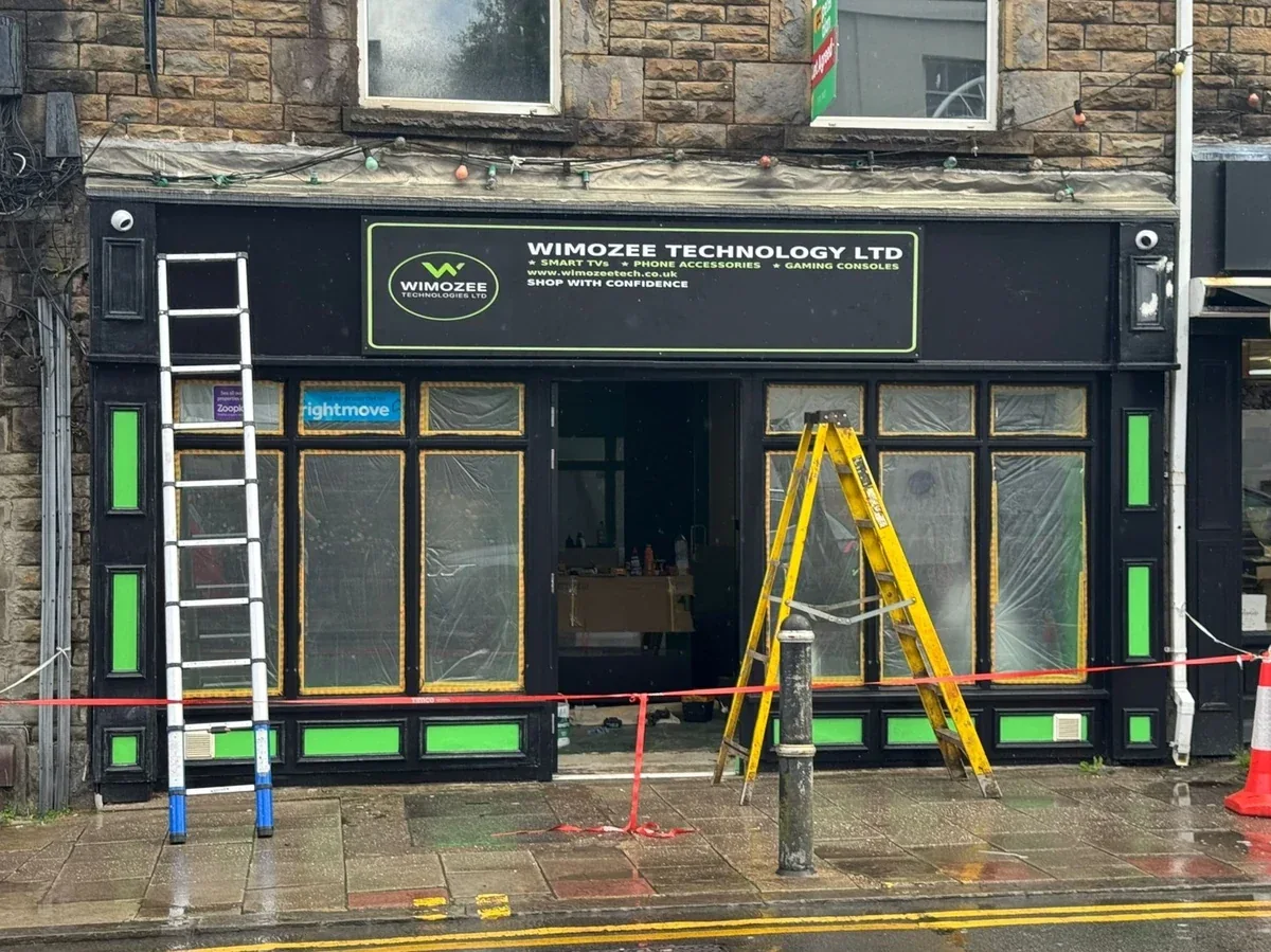 Wimozee Technology high-street shopfront in Swansea with black fascia and green accents, by Daffodil Decor