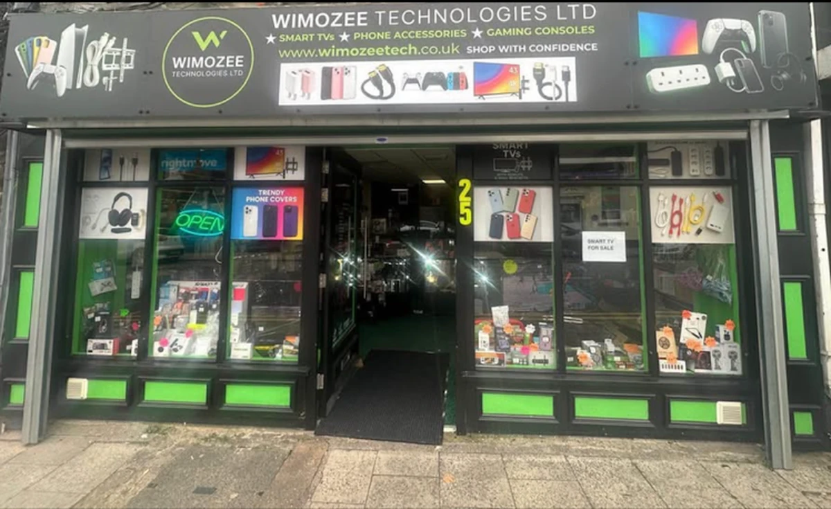Commercial fit-out in Morriston Black-and-green shopfront lit at evening after a commercial fit-out in Morriston, Swansea