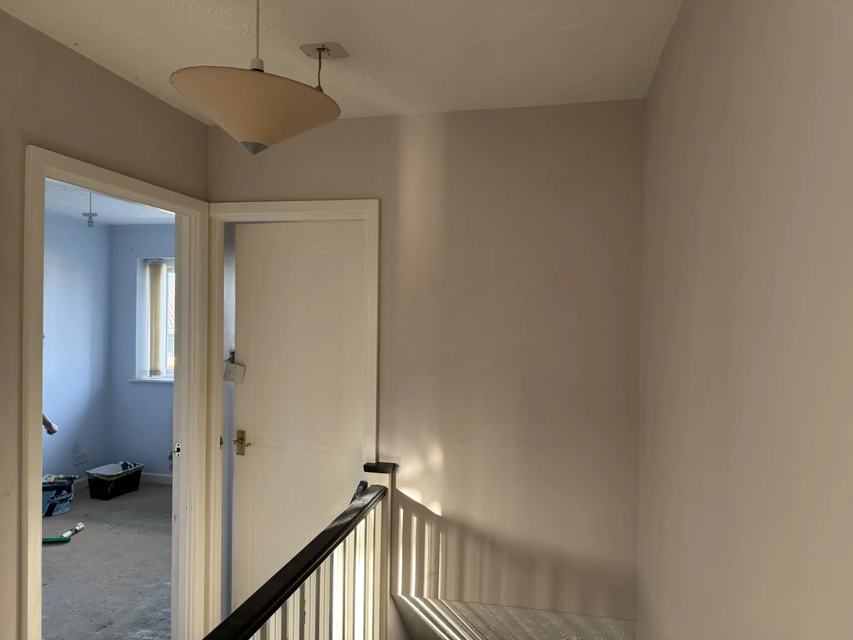 hallway-painting-landing-warm-grey-walls-blue-bedroom-view-swansea-daffodil-decor Upstairs landing with white banister and grey walls