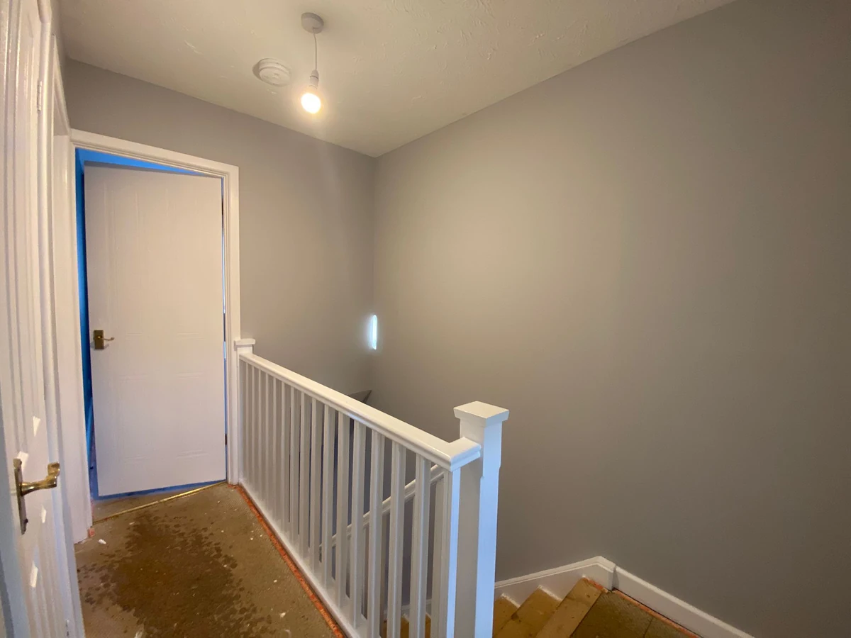 hallway-painting-upstairs-landing-white-banister-swansea-daffodil-decor Finished upstairs landing with white banister and grey walls