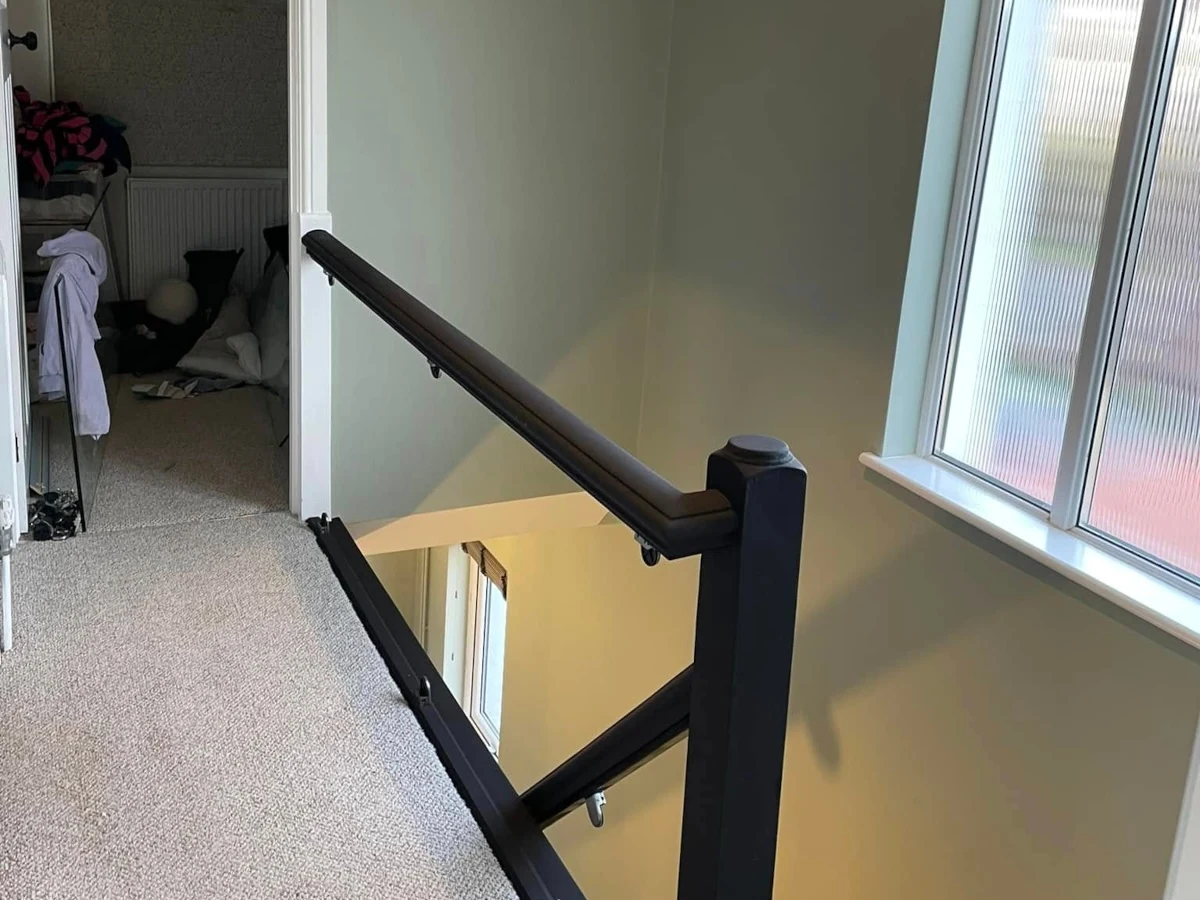 Wallpapered landing with painted banister, decorators covering Gowerton