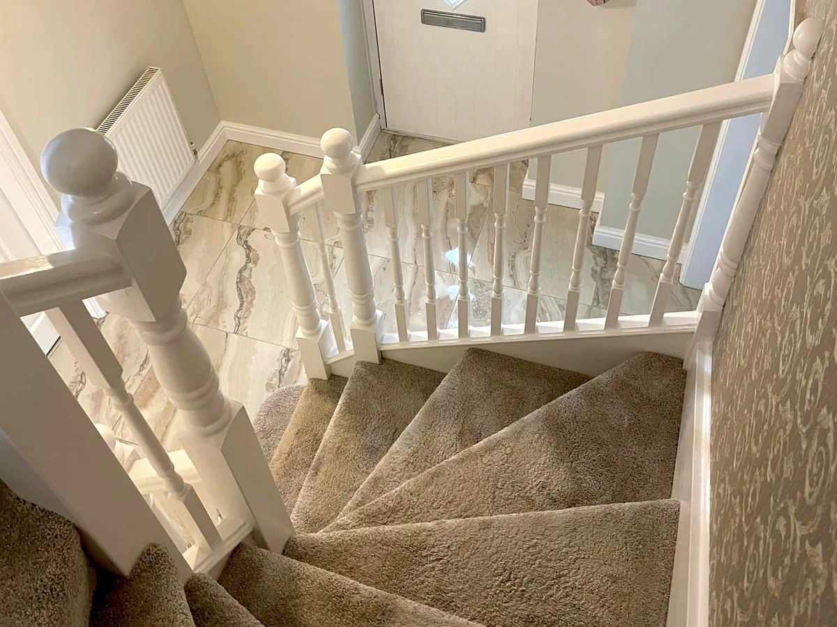 Wallpapered staircase hallway with painted banister in a Gowerton home by Daffodil Decor