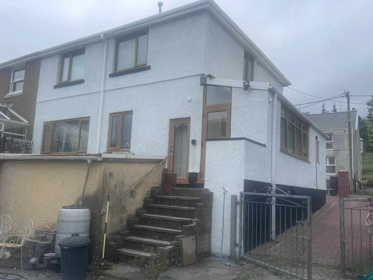 Full exterior house repaint in white masonry paint, Swansea