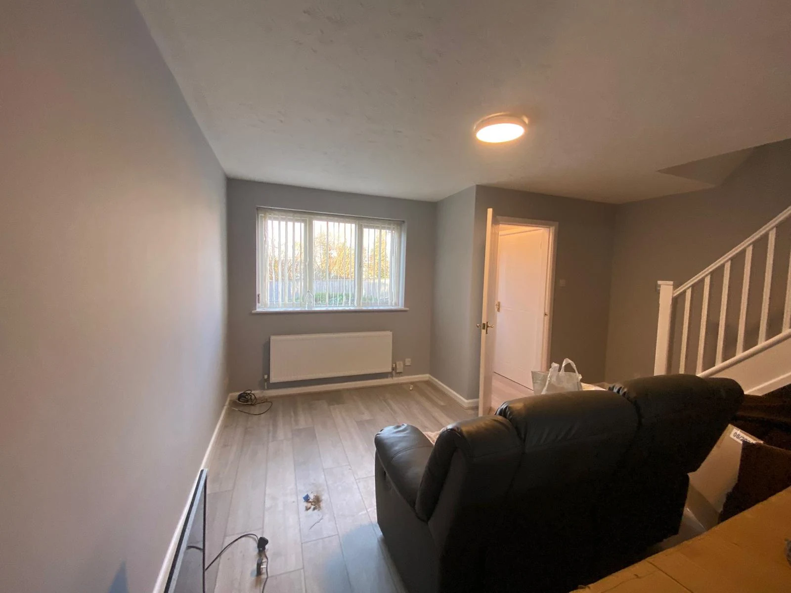 Whole-house refurbishment in Neath Living room with warm-grey walls and new LVT flooring after a whole-house refurbishment in Neath, Swansea