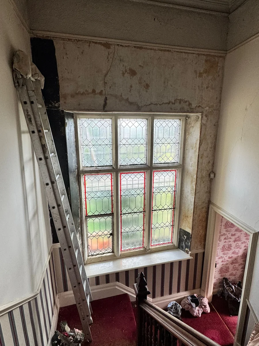period-staircase-hall-before-swansea-daffodil-decor damaged plaster and water staining above the stairs, Swansea