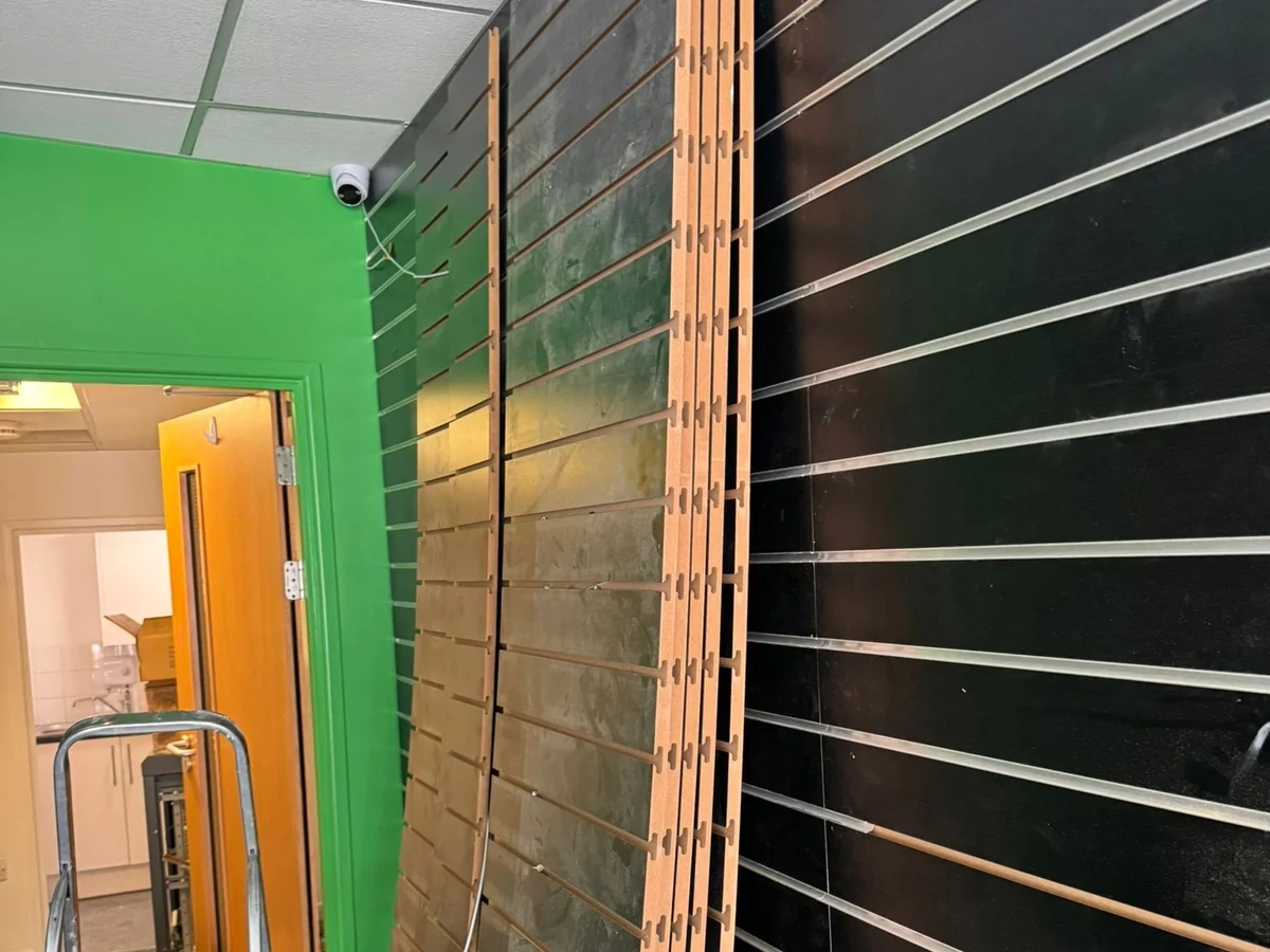 Green interior walls and rear doorway in the Wimozee Technology shop, Swansea, by Daffodil Decor