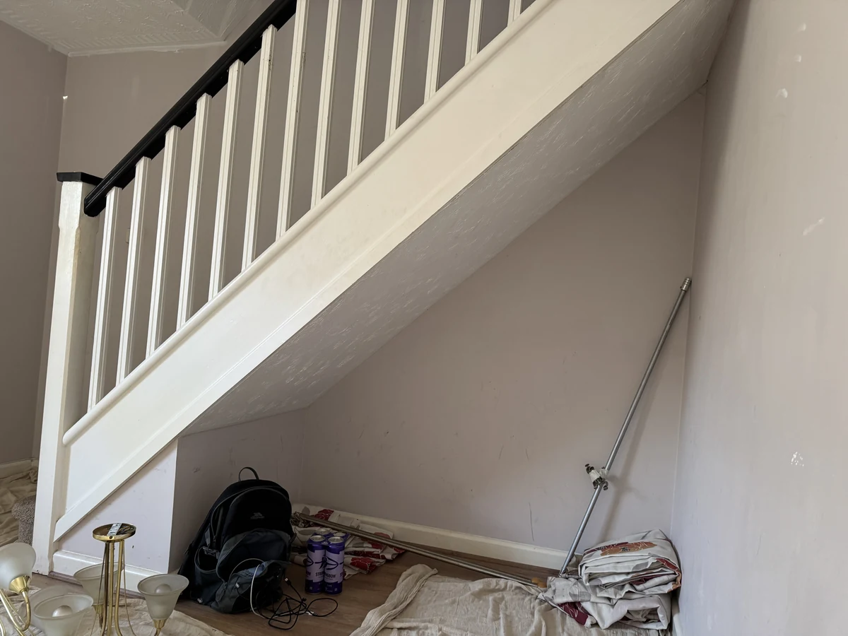 Staircase painting with white spindles and black handrail in Loughor